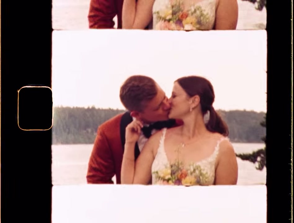 Geri and Josh kissing by the water
