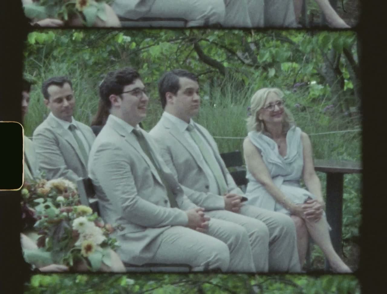 Groomsmen in pale suits waiting at the ceremony