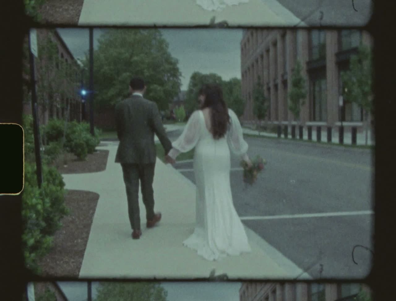 Kirsten and Tucker walking down an empty street, hand in hand
