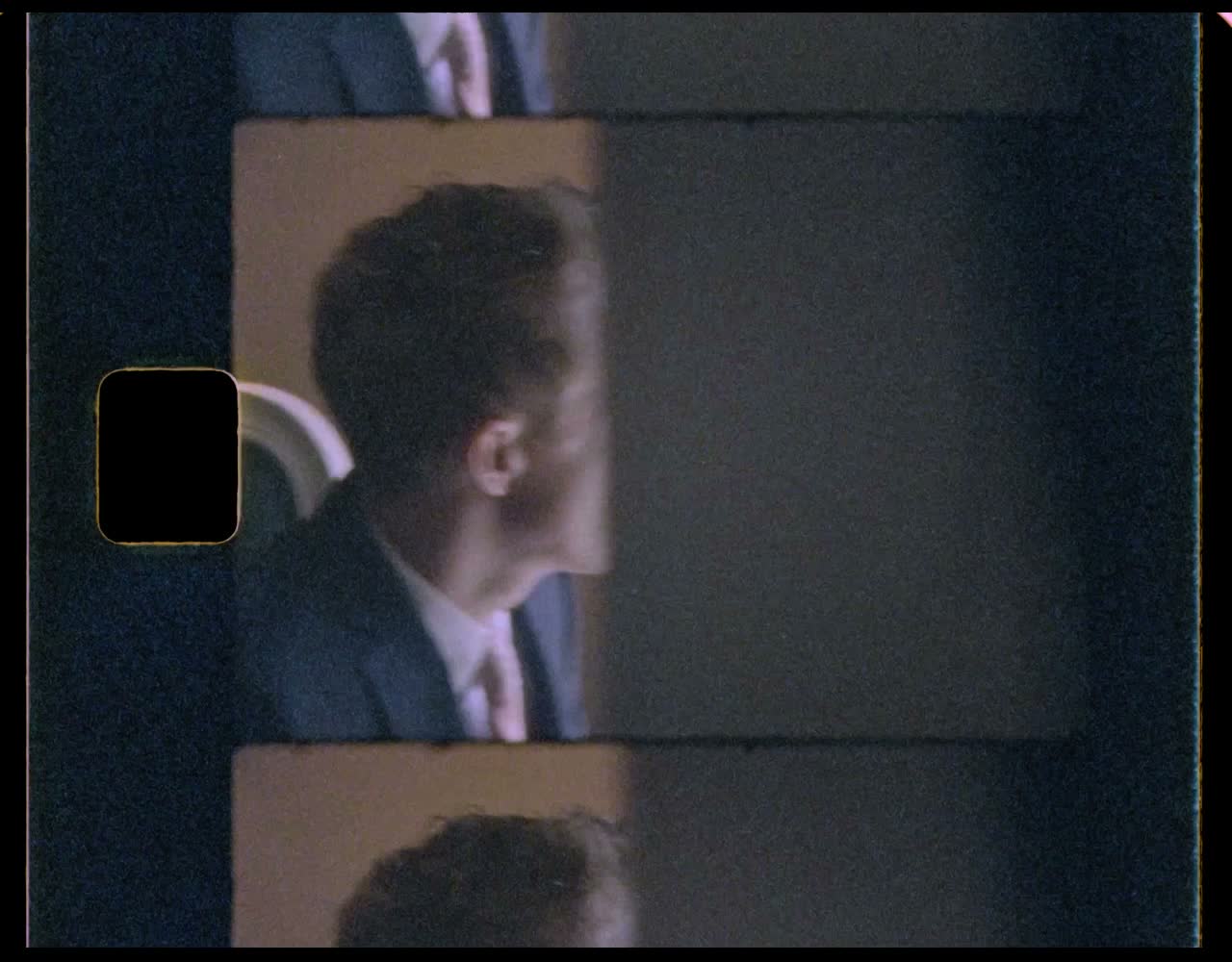 Groom fixing his tie in a round mirror
