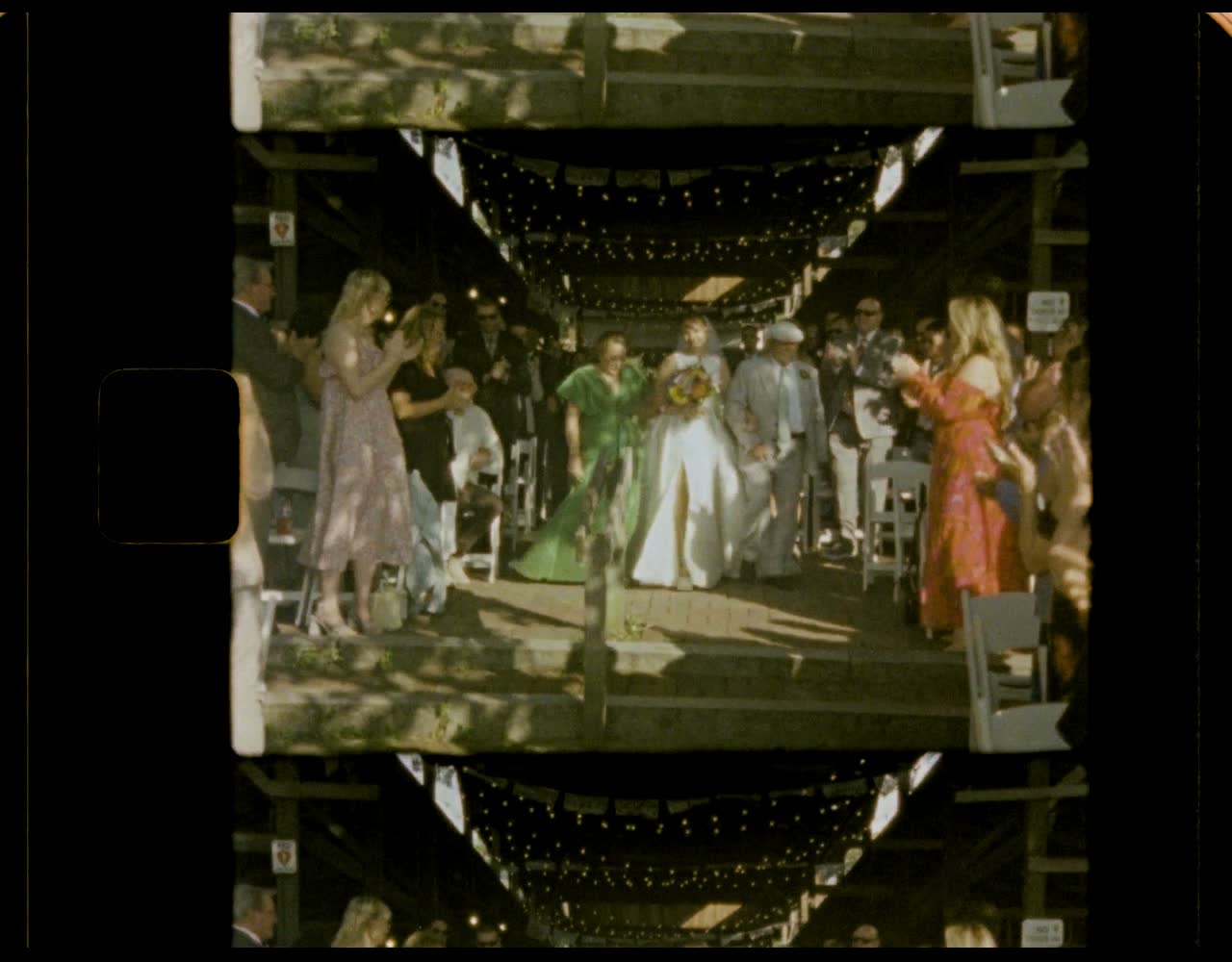 Guests lining a lit walkway under string lights